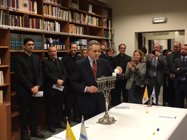 Rabbi Daniel Polish, Chair, IJCIC,  lighting the Chanukah Menorah in the Library of Cardinal Koch in Vatican office, December 2017.