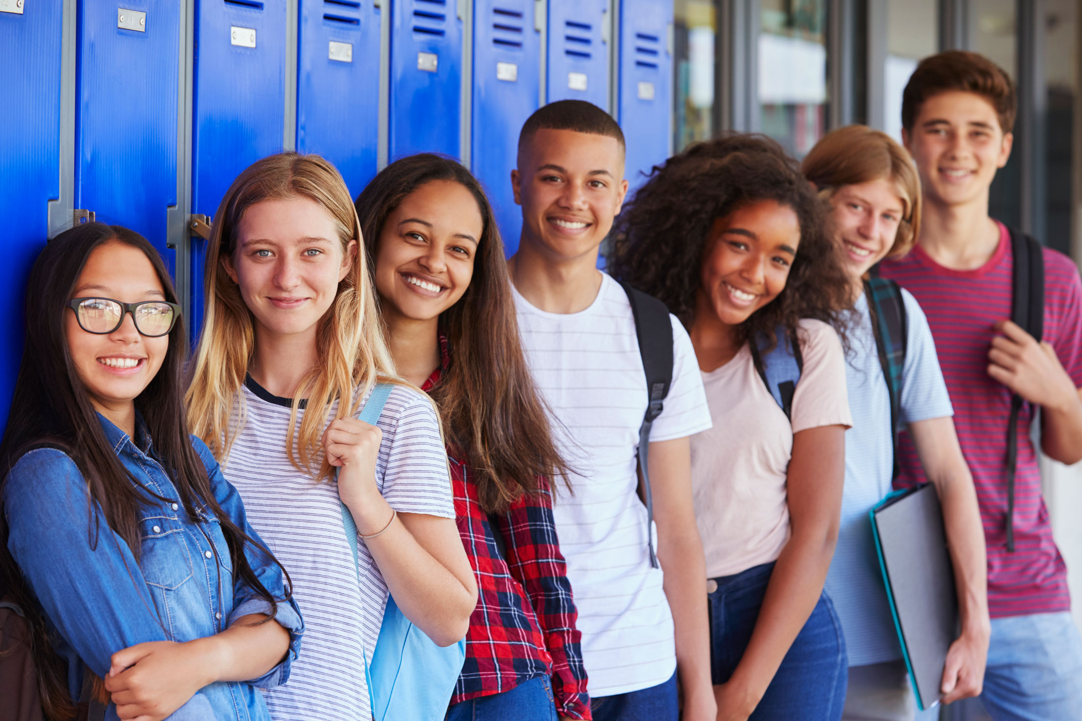 Teenage School Kids Smiling in School Corridor