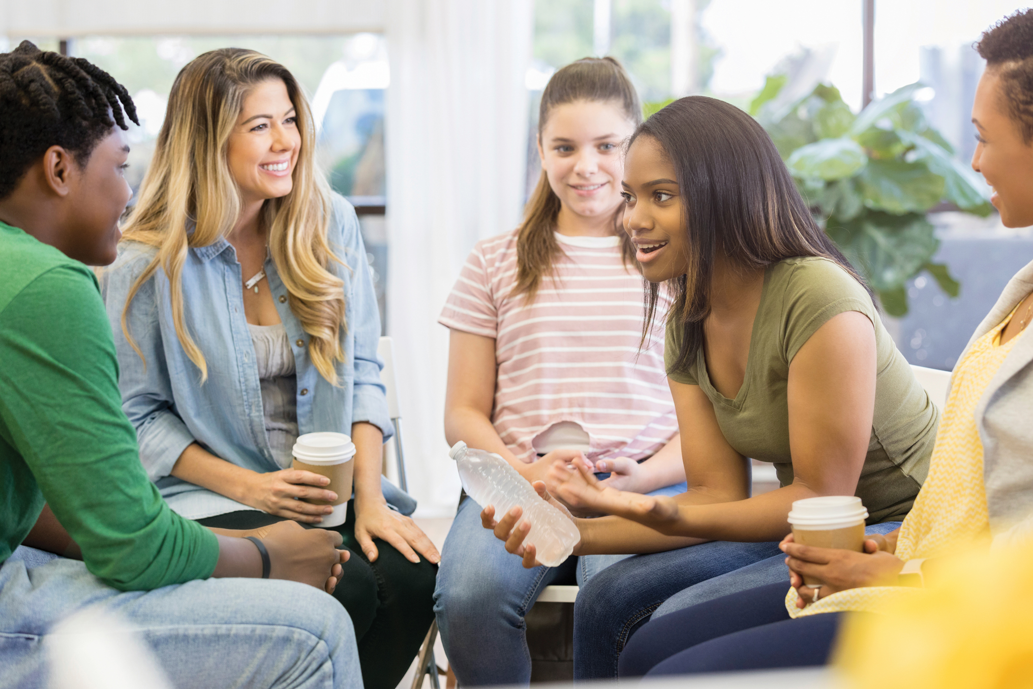 Young Woman Uses Humor When Sharing with Support Group