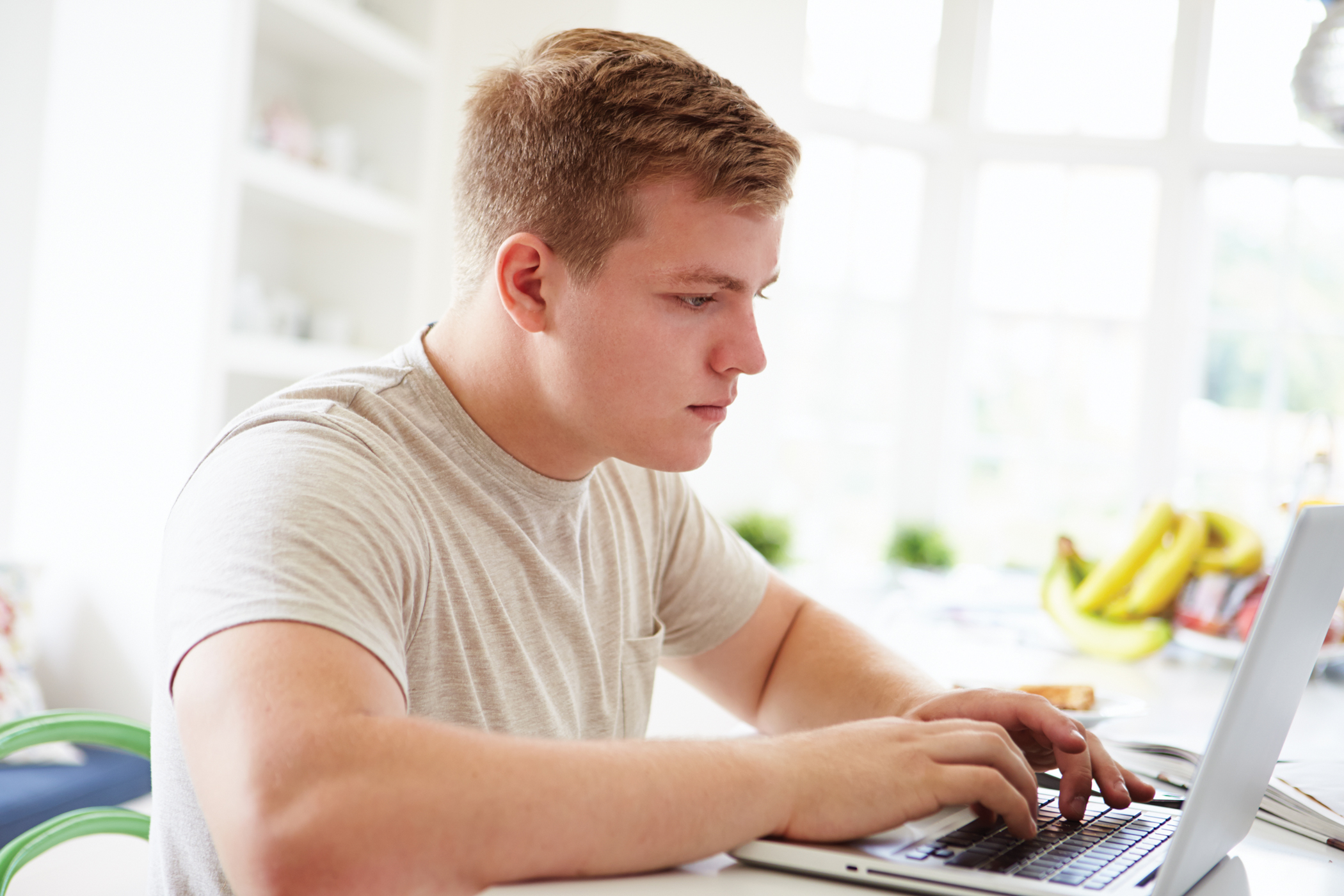 Teenage Boy on Laptop at Home