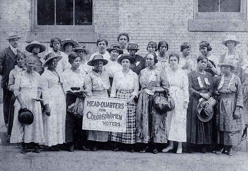 African American women standing in front of the headquarters for colored women voters