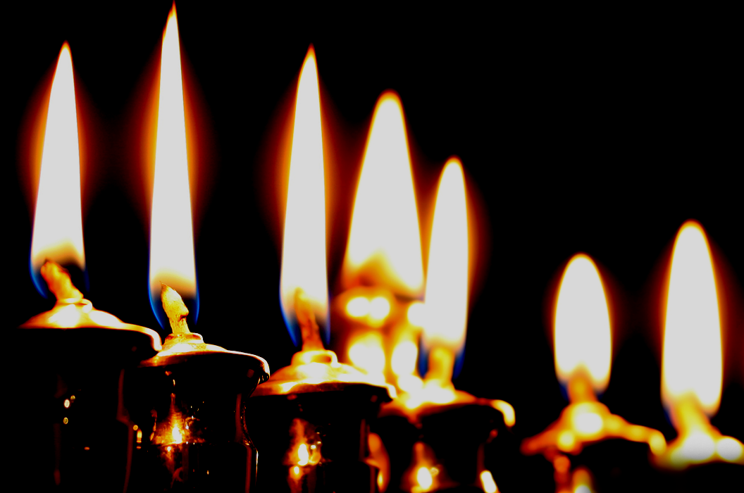Lit candles against dark background