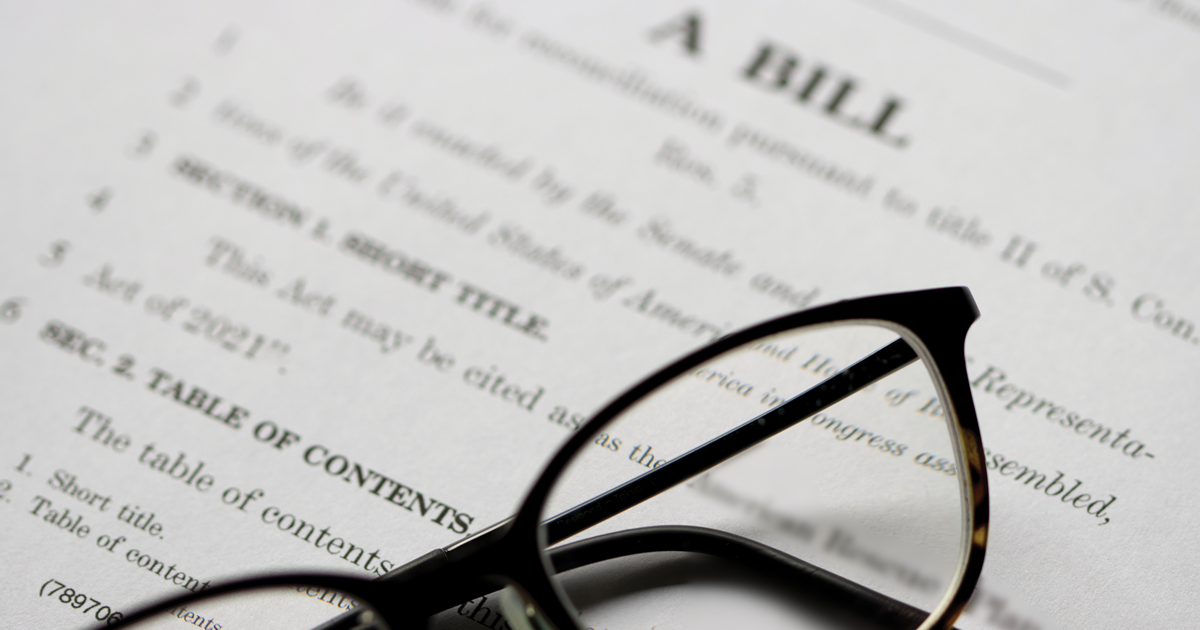 Eyeglasses laying on top of a bill legislation