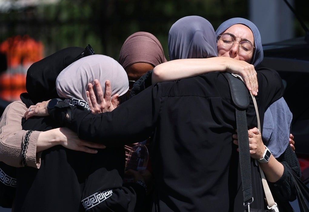 Mosque members embrace in the parking lot of the Islamic Center of San Diego (ICSD) on May 19, 2026