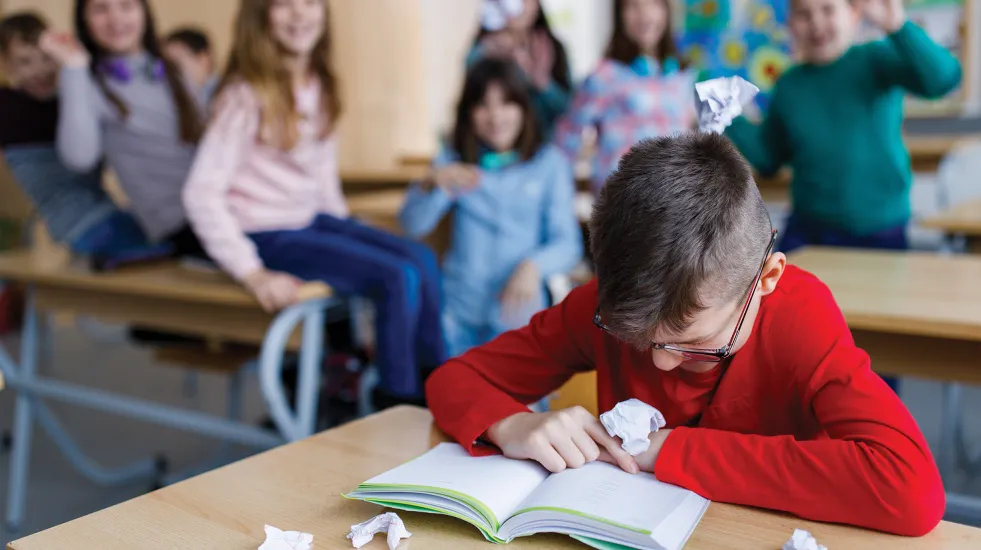 Boy being bullied inside the classroom
