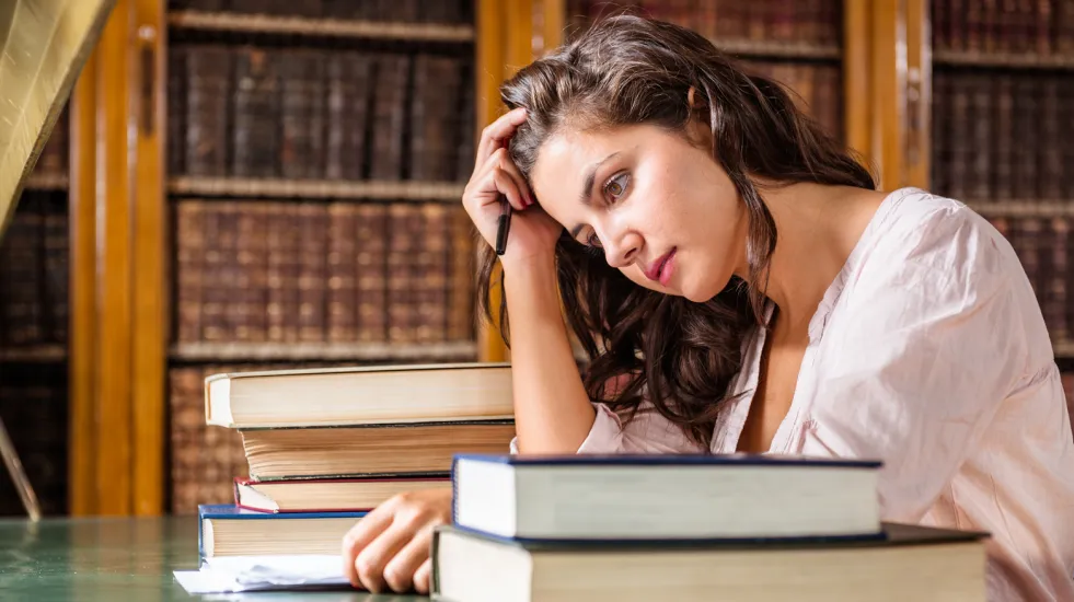 Stressed woman during an exams on the classroom
