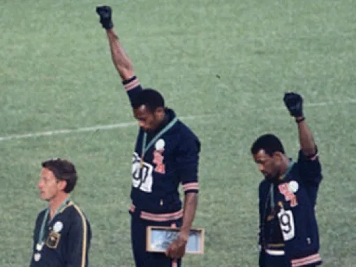 American gold medalist Tommie Smith (center) and bronze medalist John Carlos (right) with raised fists at 1968 Summer Olympics