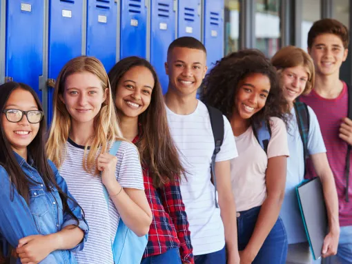 Teenage School Kids Smiling in School Corridor