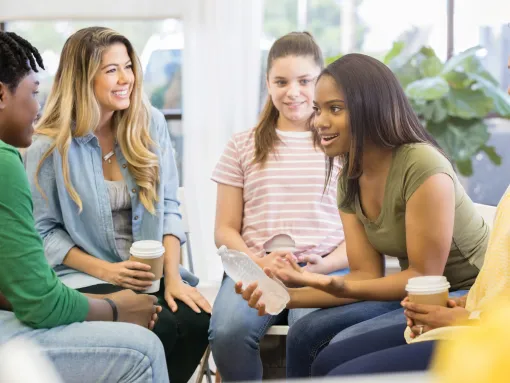 Young Woman Uses Humor When Sharing with Support Group