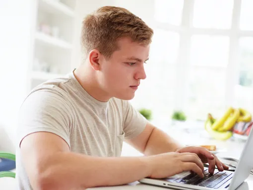 Teenage Boy on Laptop at Home