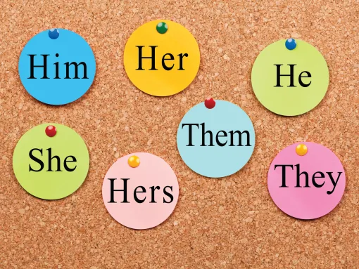 Board with various stickies of pronouns written on each