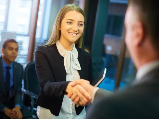 Young woman shakes hands at interview