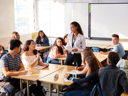 Female High School Teacher Standing Teaching Lesson in a classroom