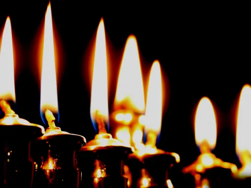 Lit candles against dark background