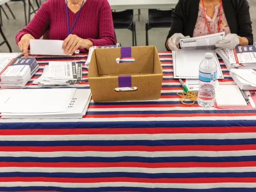 Volunteers counting mail-in ballots during an election