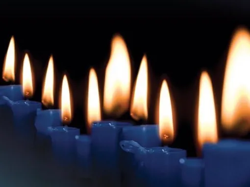 Diagonal row of burning candles