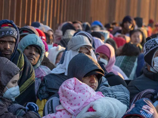 Immigrants bundle up against the cold