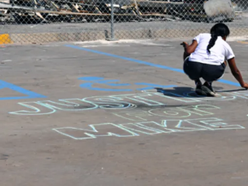 Girl Writes Justice for Mike Brown in Chalk Ferguson Missouri
