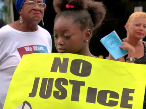 Girl Holding No Justice Sign