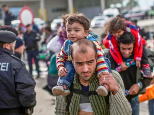 Syrian Refugees Men Carrying Children 2015