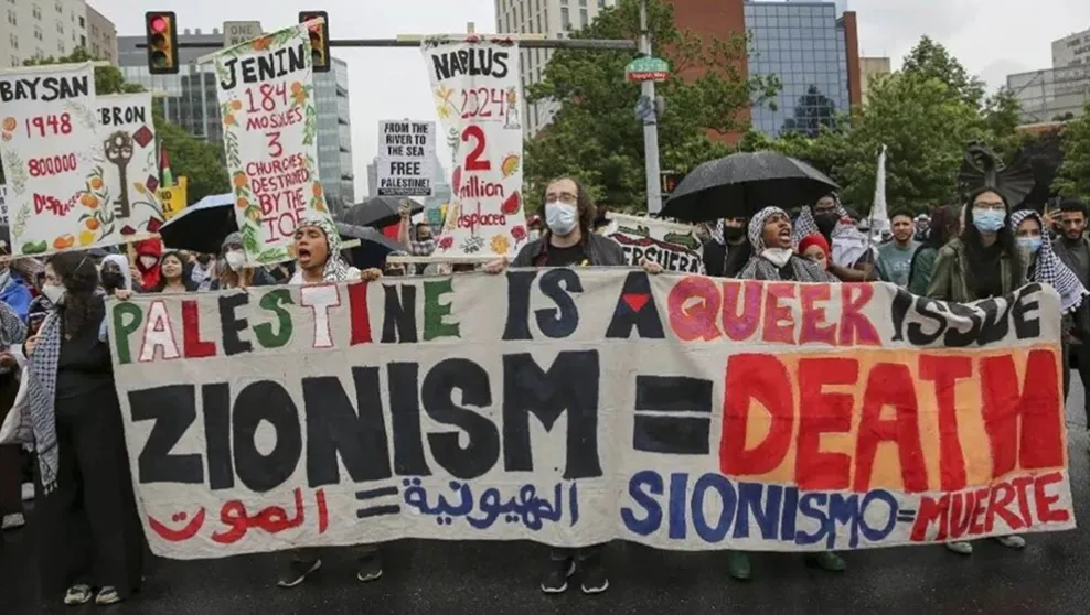 Anti-Israel protesters display a banner that features the message "Zionism = Death" during a Nakba Day protest in Philadelphia, PA on May 18, 2024.