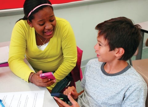 Female and Male Students Holding Cellphones Debating