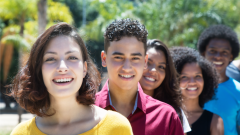 Caucasian, Latin, African American, Hispanic Young Adults standing behind one another