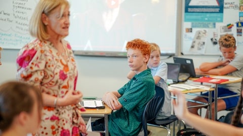 Teacher speaking to students in a classroom