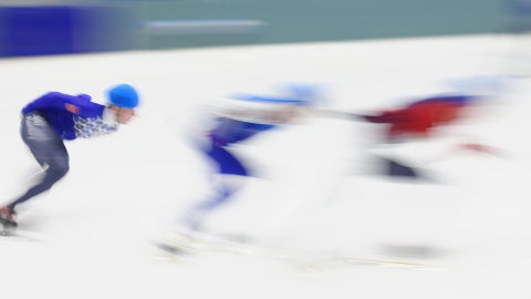 Speed Skaters racing around an ice rink
